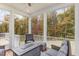 Relaxing screened porch with wooded views and seating area at 123 Stone Park Dr, Wake Forest, NC 27587