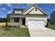 Charming single-Gathering home featuring a two-car garage, manicured lawn, and craftsman-style architecture at 137 Pretty Run Branch Ln, Wendell, NC 27591