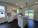 Bright kitchen featuring white cabinets, a kitchen island with granite countertops, and stainless steel appliances at 137 Pretty Run Branch Ln, Wendell, NC 27591