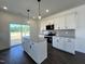 Open-concept kitchen with a large island, granite countertops, stainless steel appliances, and wood flooring at 137 Pretty Run Branch Ln, Wendell, NC 27591