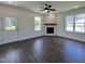 Bright living room featuring wood flooring, a ceiling fan, and a modern fireplace with mantle at 137 Pretty Run Branch Ln, Wendell, NC 27591