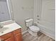 Clean bathroom with tub, toilet and vanity at 1527 Haywards Heath Ln, Apex, NC 27502