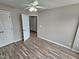 Bright bedroom with wood-look floors and ceiling fan at 1527 Haywards Heath Ln, Apex, NC 27502