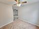 Bedroom with carpeted flooring and ceiling fan, open to living area at 1527 Haywards Heath Ln, Apex, NC 27502
