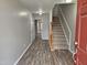 Bright and airy entryway with laminate wood flooring and staircase at 1527 Haywards Heath Ln, Apex, NC 27502