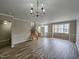 Bright living room featuring hardwood floors and a chandelier at 1527 Haywards Heath Ln, Apex, NC 27502