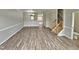 Spacious living room, hardwood floors, and stairs to upper level at 1527 Haywards Heath Ln, Apex, NC 27502