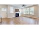 Spacious living room with hardwood floors, fireplace, and large windows at 2024 Chipley Dr, Cary, NC 27519