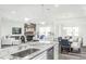 Kitchen island with granite countertop, sink, and dishwasher; open layout at 2507 Seacoast Ave, Durham, NC 27703