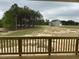 View from deck showing backyard leading to a home surrounded by mature trees creating a serene setting at 292 Weddington Way, Benson, NC 27504