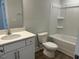 Bright bathroom featuring a tub with shower, toilet and a vanity with a white countertop and cabinets at 292 Weddington Way, Benson, NC 27504