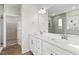 Bathroom features double sinks, white vanity, tile shower, and tiled floors at 292 Weddington Way, Benson, NC 27504
