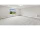 Spacious bedroom with plush carpet, large window, and neutral color palette at 292 Weddington Way, Benson, NC 27504
