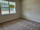 Neutral carpet in a cozy bedroom with a large window and natural light at 292 Weddington Way, Benson, NC 27504