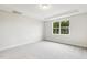 Cozy bedroom featuring a neutral carpet and a large window offering abundant natural light at 292 Weddington Way, Benson, NC 27504