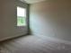 Cozy bedroom with plush carpet and a large window offering ample natural light at 292 Weddington Way, Benson, NC 27504