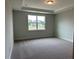Carpeted bedroom featuring a tray ceiling, recessed lighting, and a large window at 292 Weddington Way, Benson, NC 27504