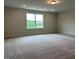 Large bonus room featuring soft carpet, recessed lighting, and a sunlit window at 292 Weddington Way, Benson, NC 27504