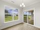 Bright dining area featuring large windows and slider doors to the backyard at 292 Weddington Way, Benson, NC 27504