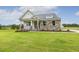 Attractive home with stone accents, a cozy porch, and a well-maintained lawn at 292 Weddington Way, Benson, NC 27504