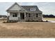 Charming single-Gathering home showcasing stone accents, dormer window, and a covered front porch at 292 Weddington Way, Benson, NC 27504