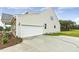 Exterior shot of the home showcasing the garage and a partial view of the siding and stone at 292 Weddington Way, Benson, NC 27504