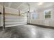Spacious two car garage with concrete floor, windows, and automatic door at 292 Weddington Way, Benson, NC 27504