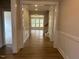 Inviting hallway features hardwood floors and opens to a bright, airy living space with lots of windows at 292 Weddington Way, Benson, NC 27504