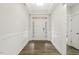 Bright hallway with dark wood floors and decorative wall paneling at 292 Weddington Way, Benson, NC 27504