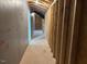 Unfinished hallway with exposed framing, insulation and wiring ready for custom finishes and design at 292 Weddington Way, Benson, NC 27504