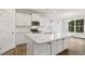 Modern kitchen features white cabinets, stainless steel appliances, granite countertops, and large island at 292 Weddington Way, Benson, NC 27504