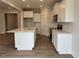 Spacious kitchen featuring a large island with granite countertops, stainless appliances, and ample cabinet space at 292 Weddington Way, Benson, NC 27504