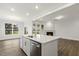 Kitchen island with stainless steel dishwasher and view to the living room at 292 Weddington Way, Benson, NC 27504