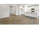 Open-concept living space showing hardwood floors, kitchen with granite counters, and white cabinets at 292 Weddington Way, Benson, NC 27504
