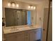 Elegant bathroom featuring double sinks, a large mirror, and modern lighting fixtures at 308 Whispering Way, Sanford, NC 27330