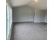 Large carpeted room with neutral paint and bright, natural light from windows at 308 Whispering Way, Sanford, NC 27330