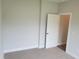 Cozy bedroom with gray carpet, white trim, and a view of the closet at 308 Whispering Way, Sanford, NC 27330