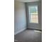 Bedroom features plush carpet and a window with a pleasant outdoor view at 308 Whispering Way, Sanford, NC 27330