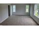 Spacious bedroom featuring neutral walls, plush carpeting and abundant natural light from two large windows at 308 Whispering Way, Sanford, NC 27330