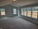 Spacious, carpeted room with vaulted ceiling and bright, natural light from large windows at 308 Whispering Way, Sanford, NC 27330