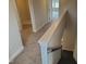 Hallway featuring neutral paint, plush carpeting, and white trim leading to various rooms at 308 Whispering Way, Sanford, NC 27330