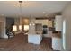 Bright kitchen showcasing white cabinetry, stainless steel appliances, and a center island with seating at 308 Whispering Way, Sanford, NC 27330