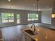 Kitchen with stainless steel appliances, island sink, and backyard view at 308 Whispering Way, Sanford, NC 27330