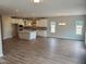 Spacious open-concept living room with a large kitchen and hardwood floors at 308 Whispering Way, Sanford, NC 27330