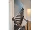 Elegant staircase with dark wood railing and black iron spindles at 308 Whispering Way, Sanford, NC 27330
