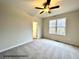 Spacious bedroom with carpeting, a large window, and access to a bathroom at 313 Springtooth Dr, Zebulon, NC 27597