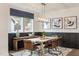 Elegant dining room with a wood table, leather chairs, and dark-colored walls at 3391 Mission Olive Pl, New Hill, NC 27562