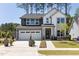 Two-story home with gray and white siding, landscaping, and a two-car garage at 3391 Mission Olive Pl, New Hill, NC 27562