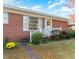 Brick ranch house with front porch, landscaping, and walkway at 3600 Nc 561, Louisburg, NC 27549
