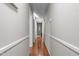 Long hallway with hardwood floors and white wainscoting at 3969 Carbonton Rd, Sanford, NC 27330